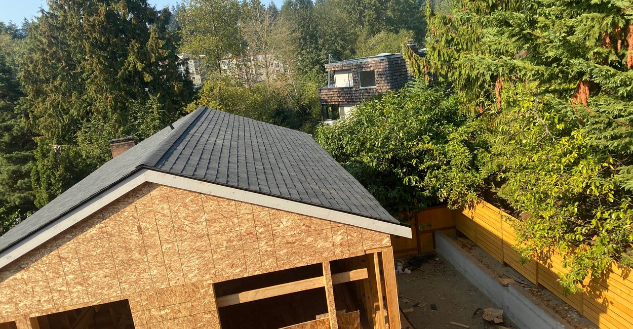 Roofing work in progress on multi-story home