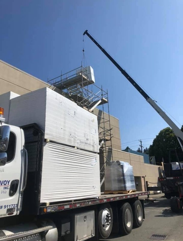 Delivery truck unloading roofing materials