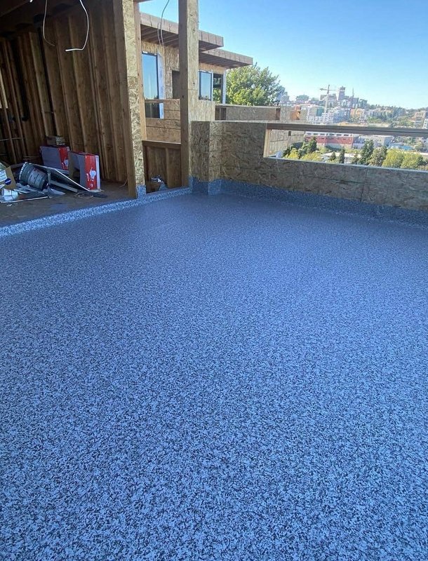 New roof coating applied to flat residential roof