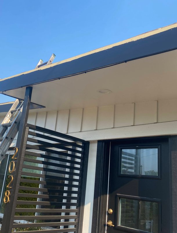 Home with new asphalt shingle roof and gutters