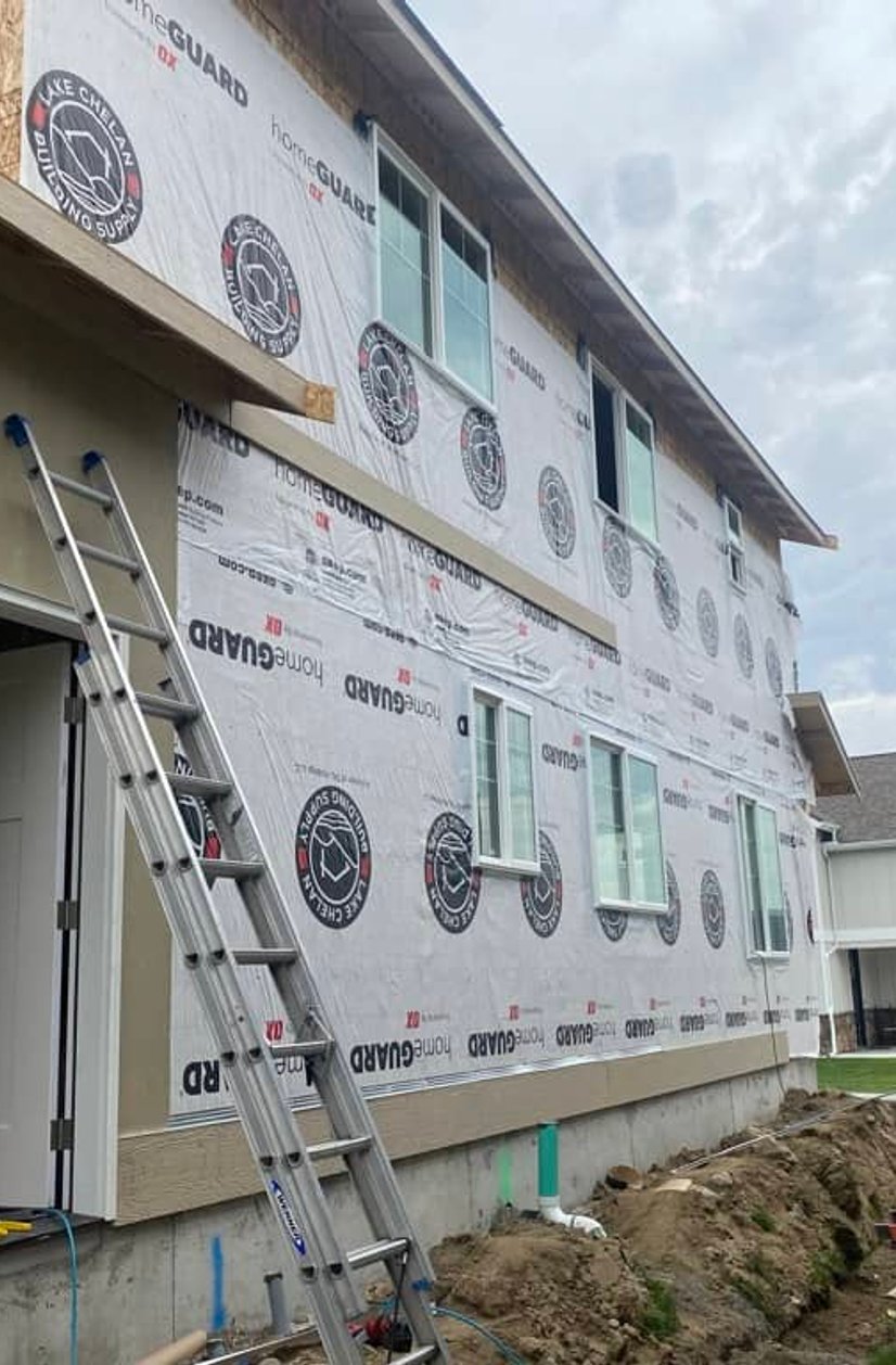 Exterior home renovation showing new roofing work