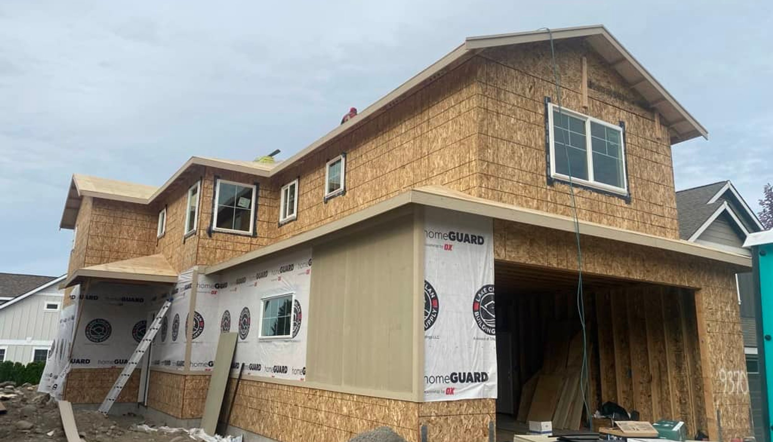 Roofing contractor installing new roof on home